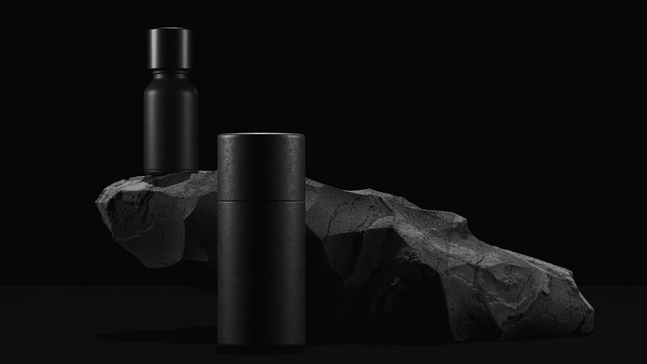 bottle of essential massage oil on stone beauty treatment minimal black design packaging mock up.jpg