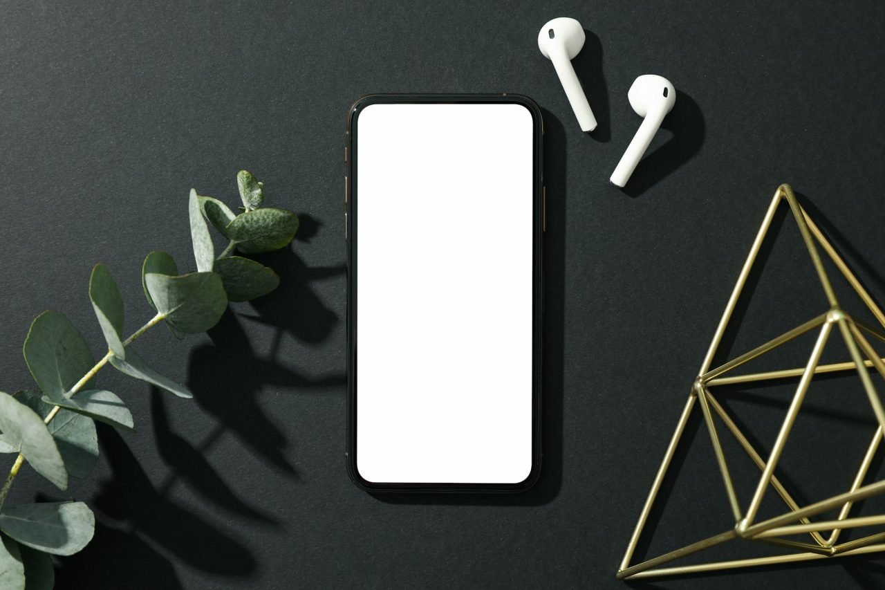 phone with empty screen on black decorated background top view.jpg